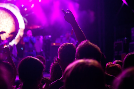 crowd with raised hands at concert - summer music festivalの写真素材