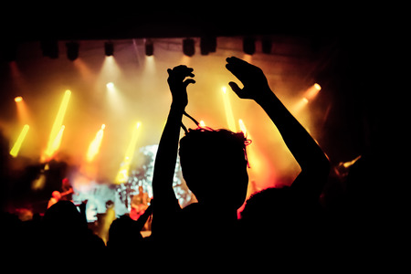 crowd with raised hands at concert - summer music festivalの写真素材