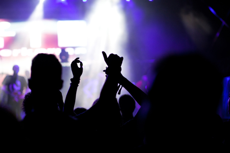 crowd with raised hands at concert - summer music festivalの写真素材