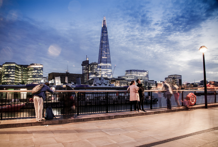 LONDON, UK - JULY 17, 2017: tourists on the South bank watching London skyline with the Shard at nightのeditorial素材