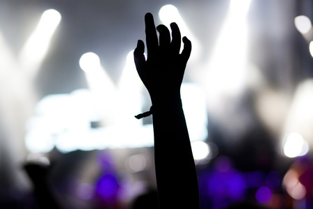 crowd with raised hands at concert - summer music festivalの写真素材