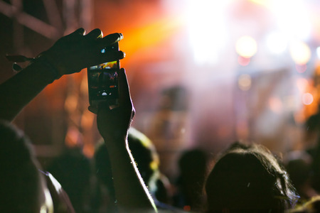 crowd with raised hands at concert - summer music festival