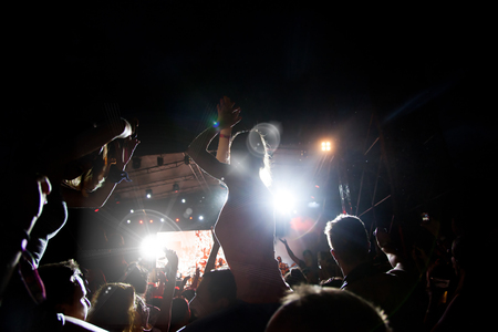 crowd with raised hands at concert - summer music festivalの写真素材