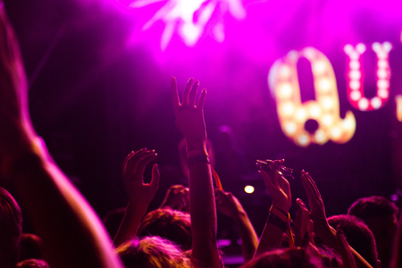 crowd with raised hands at concert - summer music festivalの写真素材