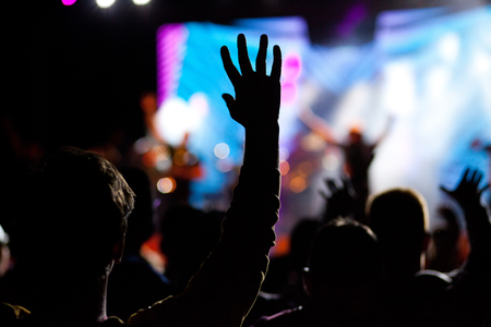 crowd with raised hands at concert - summer music festivalの写真素材
