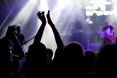crowd with raised hands at concert - summer music festival