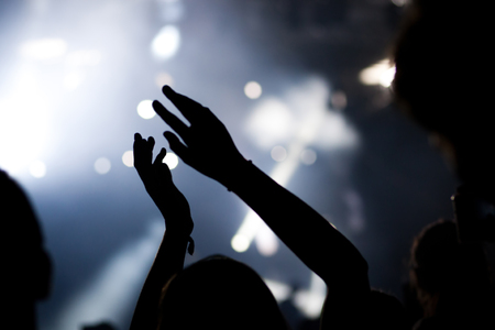 crowd with raised hands at concert - summer music festivalの写真素材