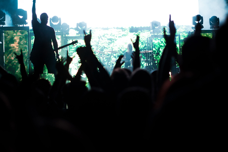crowd with raised hands at concert - summer music festivalの写真素材
