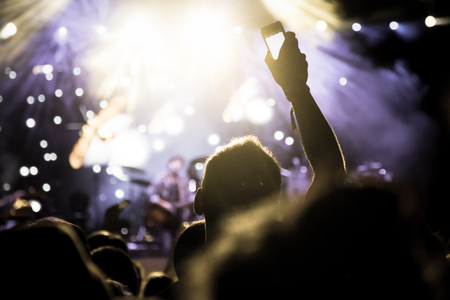 crowd with raised hands at concert - summer music festivalの写真素材