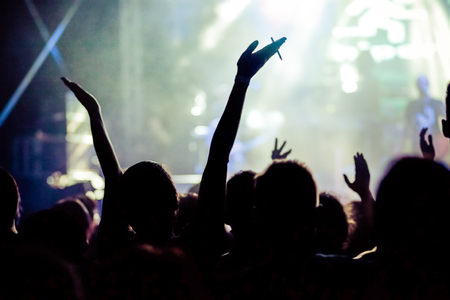 crowd with raised hands at concert - summer music festivalの写真素材