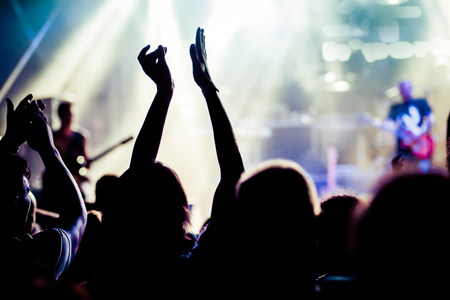 crowd with raised hands at concert - summer music festivalの写真素材