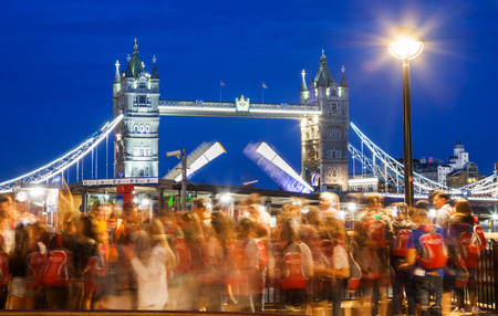 LONDON, UK - JULY 17, 2017: crowd of tourists watching Tower Bridge in the evening being raised upのeditorial素材