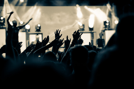 crowd with raised hands at concert - summer music festival