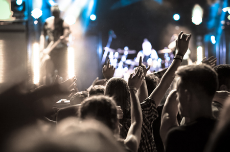 crowd with raised hands at concert - summer music festivalの写真素材
