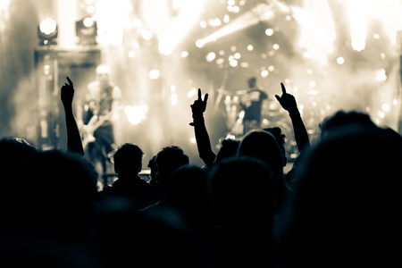 crowd with raised hands at concert - summer music festivalの写真素材