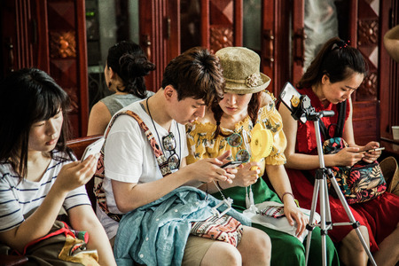 HO CHI MINH CITY (SAIGON), VIETNAM - JULY 2017 : tourists inside the central post office in neoclassical architectural style, designed and constructed by the famous architect Gustave Eiffel.のeditorial素材