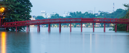 hanoi Red Bridge at night. The wooden red-painted bridge over the Hoan Kiem Lake connects the shore and the Jade Island on which Ngoc Son Temple stands.の写真素材