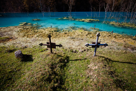 church with its cemetery under contaminated water in Geamana, Romania. Polluted lake with mining residuals that destroyed a village.の写真素材