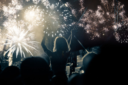 new Year concept - cheering crowd and fireworksの写真素材