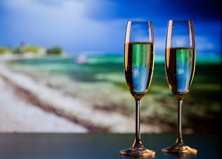 two champagne glasses on the beach - exotic New Yearの写真素材