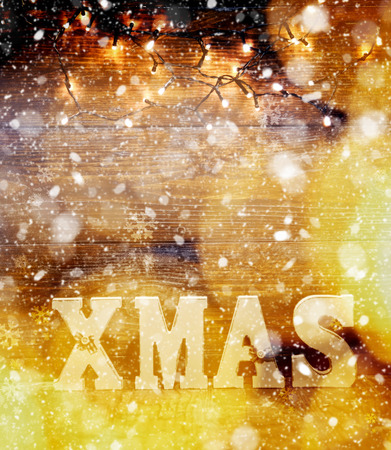 christmas decorations and lights on wooden backgroundの写真素材