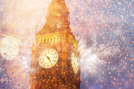 Explosive fireworks display fills the sky around Big Ben. New Year's Eve celebration in the cityの写真素材