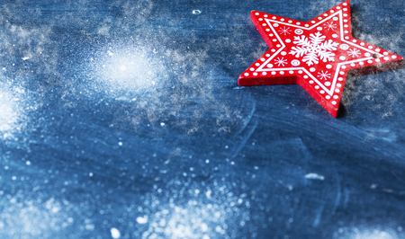 red christmas decorations on blue with snowの写真素材