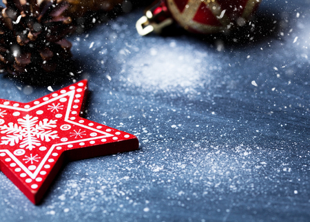 red christmas decorations on blue with snowの写真素材