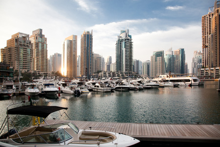 DUBAI, UAE - FEBRUARY 2018: View of modern skyscrapers shining in sunrise lights  in Dubai Marina in Dubai, UAE.のeditorial素材