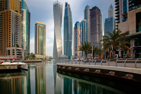 DUBAI, UAE - FEBRUARY 2018: View of modern skyscrapers shining in sunrise lights  in Dubai Marina in Dubai, UAE.のeditorial素材
