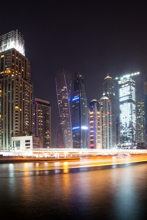 DUBAI, UAE - FEBRUARY 2018: Colorful evening on canal and promenade in Dubai Marina,Dubai,United Arab Emiratesのeditorial素材
