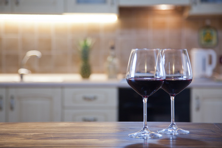 two glasses of red wine on  kitchen tableの写真素材