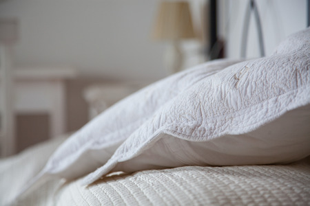 pillows on bed - bright bedroom interior designの写真素材