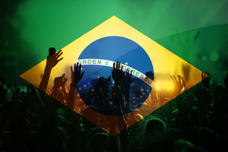 football fans supporting Brazil - double exposure of Brazil flag and crowd celebrating victoryの写真素材