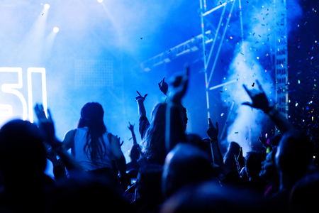 cheering crowd with raised hands at concert - music festivalの写真素材