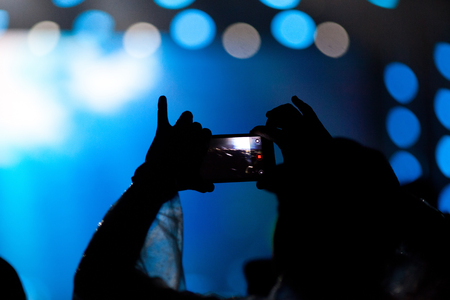 cheering crowd with raised hands at concert - music festivalの写真素材