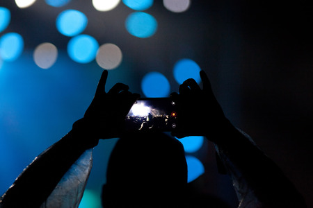 cheering crowd with raised hands at concert - music festivalの写真素材