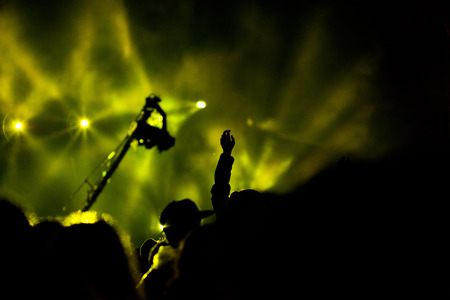 cheering crowd with raised hands at concert - music festivalの写真素材