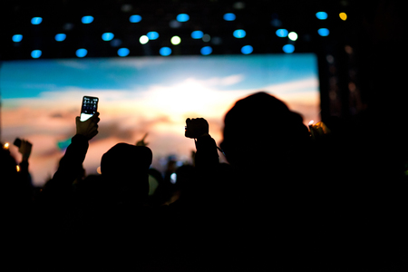 cheering crowd with raised hands at concert - music festivalの写真素材