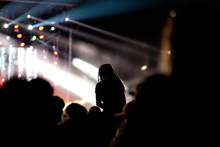 cheering crowd with raised hands at concert - music festivalの写真素材