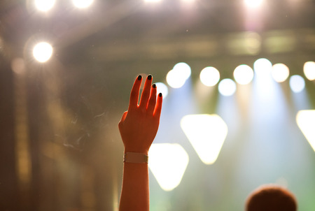 cheering crowd with raised hands at concert - music festivalの写真素材