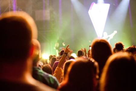 cheering crowd with raised hands at concert - music festivalの写真素材