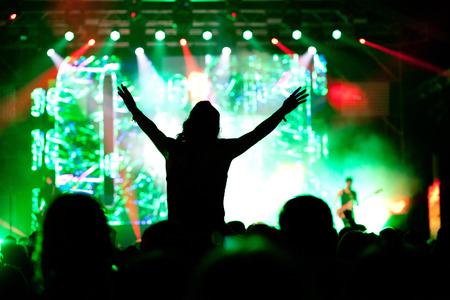 cheering crowd with raised hands at concert - music festival