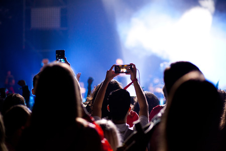 cheering crowd with raised hands at concert - music festival