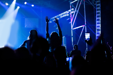 cheering crowd with raised hands at concert - music festivalの写真素材
