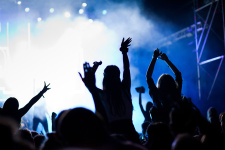 cheering crowd with raised hands at concert - music festivalの写真素材