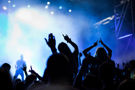 cheering crowd with raised hands at concert - music festivalの写真素材