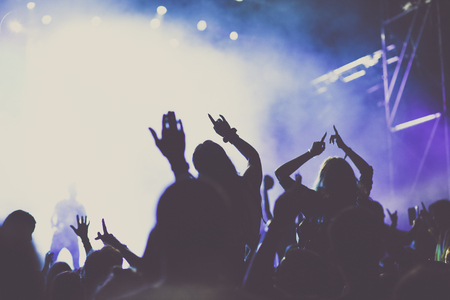 cheering crowd with raised hands at concert - music festivalの写真素材