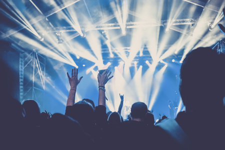 cheering crowd with raised hands at concert - music festivalの写真素材