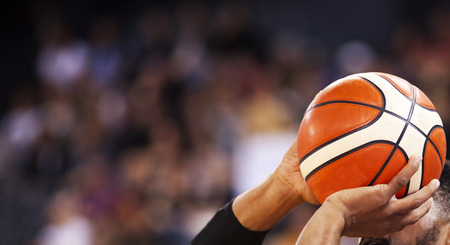 basketball player shooting three pointer during game